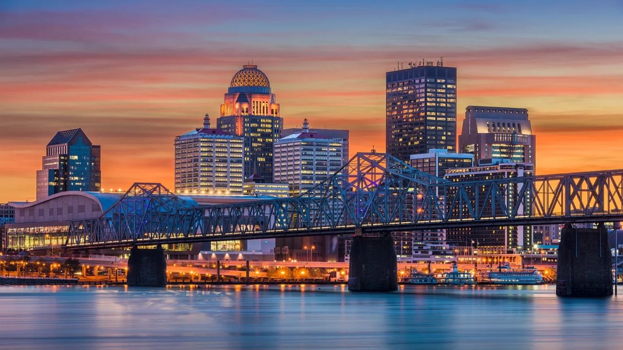 The Louisville skyline over the Ohio River at dusk